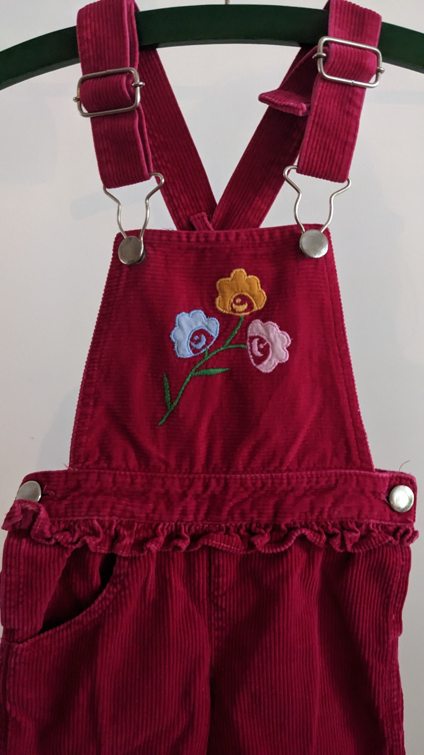 Red corduroy overall with frill and flowers