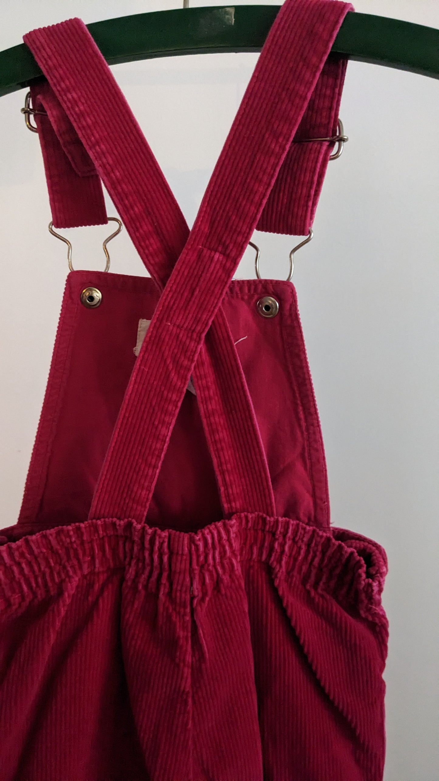 Red corduroy overall with frill and flowers